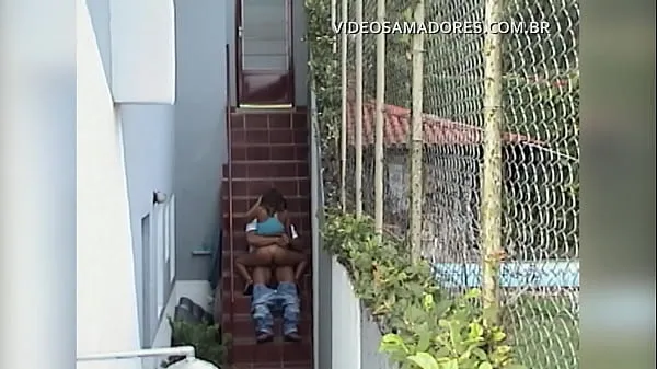 Young couple fucks in the backyard and is filmed from afar